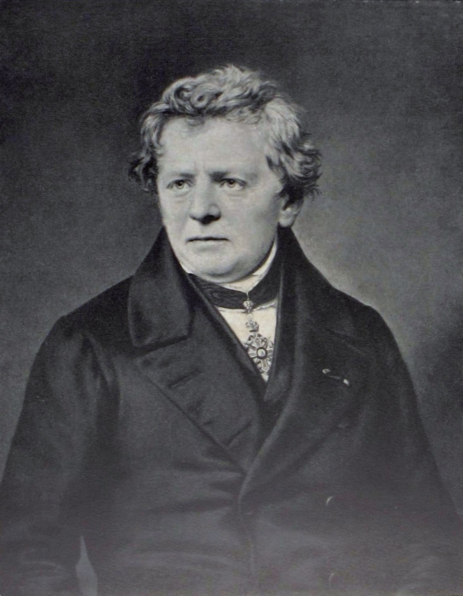 Portrait of Georg Simon Ohm: a middle-aged man in a dark high-collared coat, with unruly greying hair, looking directly out of the frame.
