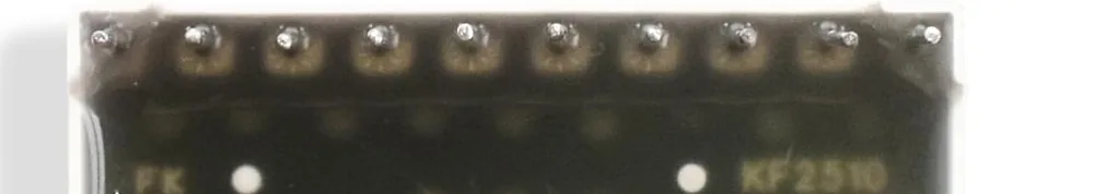 The underside of a bar graph package, translucent so the internal board shows through: ten pins along the top edge, ten along the bottom, and a row of small round LED dies visible between them with the part number printed on the board.