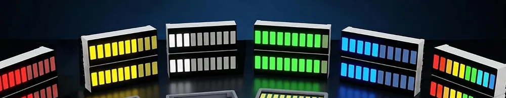 Six ten-segment bar graphs standing in a row on a dark surface, each fully lit: red, yellow, white, green, blue, and one multicolour bar whose segments run red, then yellow, then green, then blue from left to right.