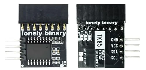 Front and back of the heavy-duty pack's adapter side by side: a tall black eight-way socket along the top edge, the chip on the front, and on the back the labels TK85, GND, VCC, SDA and SCL, three address pads marked A0, A1 and A2, and the I2C PULL UP pad.
