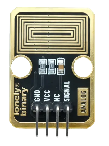 A photo of the front of the TK65, header at the bottom: a black board with a gold border and seven nested gold rectangles across its top half, a round LEGO hole at each side below them, three small parts in a row printed 1004, 1500 and a tan capacitor, lonely binary up the left edge, a gold ANALOG box on the right, and four pins labelled GND, VCC, NC and SIGNAL.