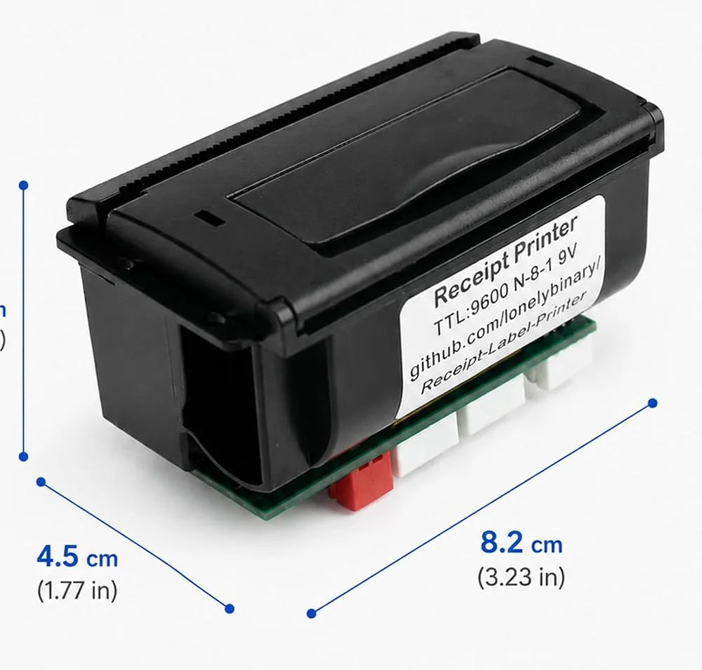 The receipt printer module at an angle: a black rectangular case about 82 by 46 by 45 millimetres with a hinged paper cover on top, a white label on the side reading Receipt Printer, TTL:9600 N-8-1 9V, github.com/lonelybinary/Receipt-Label-Printer, and a green circuit board underneath carrying three white sockets and one red one.