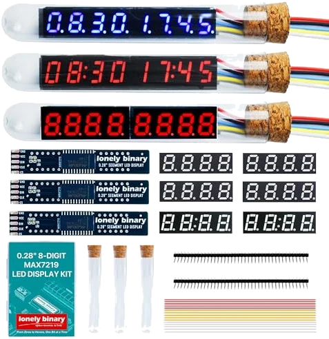 The kit laid out: three finished eight-digit displays inside glass tubes with cork stoppers, one blue and two red, above three bare dark driver boards and six loose four-digit panels, with the printed manual, three empty tubes, two pin header strips and a bundle of jumper wires below.